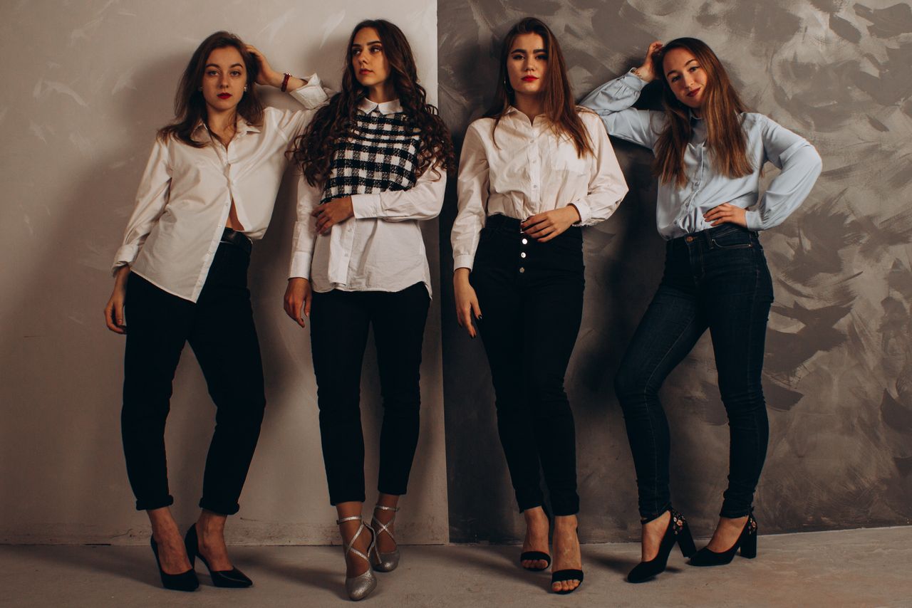 Mastering the First Impression: Your intriguing post title goes here A group of fashionable women posing in a studio wearing smart casual outfits.